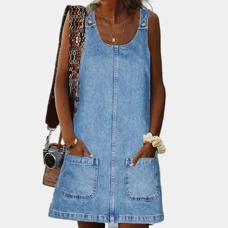 Woman wearing a sleeveless lightweight denim dress with front pockets