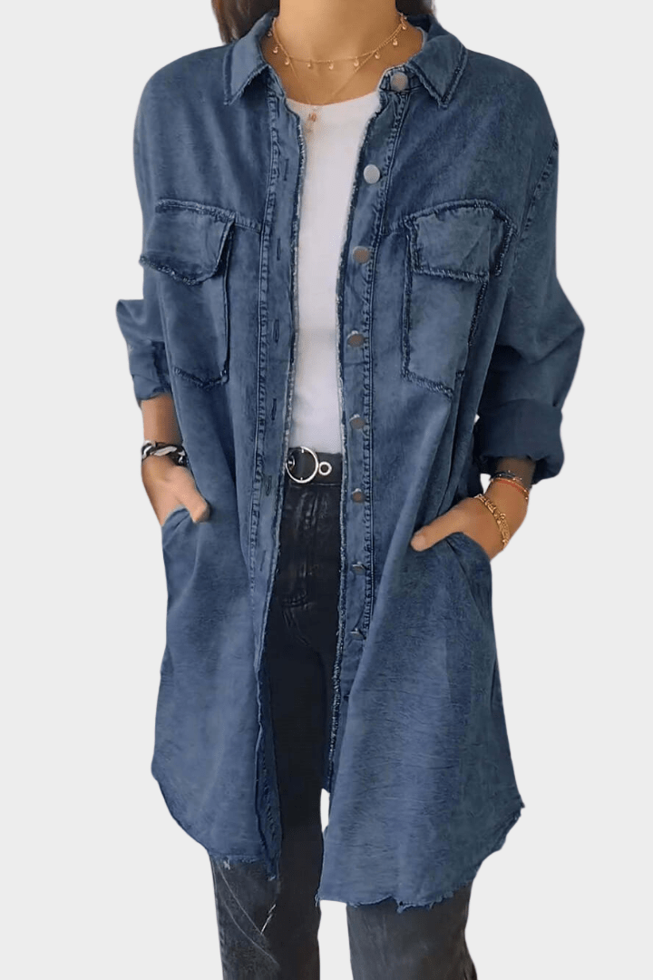 Woman wearing a long denim shirt dress with rolled sleeves and side pockets