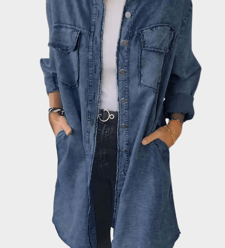 Woman wearing a long denim shirt dress with rolled sleeves and side pockets