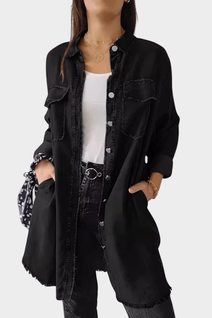 Woman wearing a long denim shirt dress with rolled sleeves and side pockets