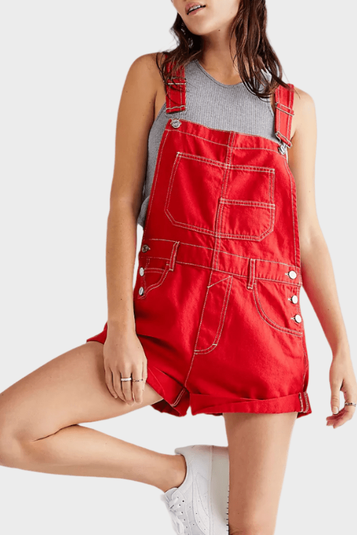 Woman wearing a denim jumpsuit with adjustable straps