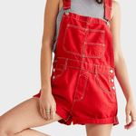 Woman wearing a denim jumpsuit with adjustable straps