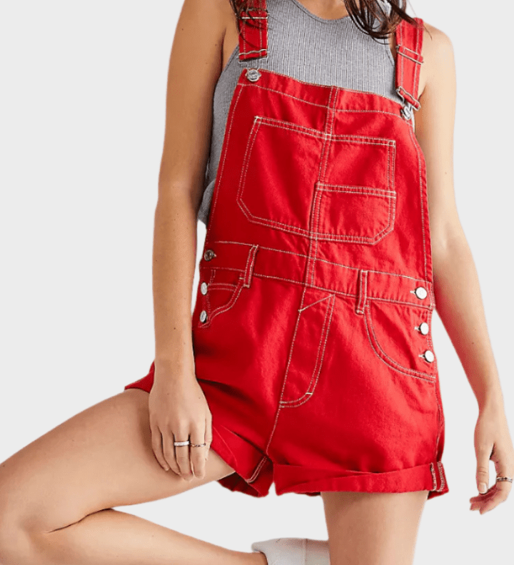 Woman wearing a denim jumpsuit with adjustable straps