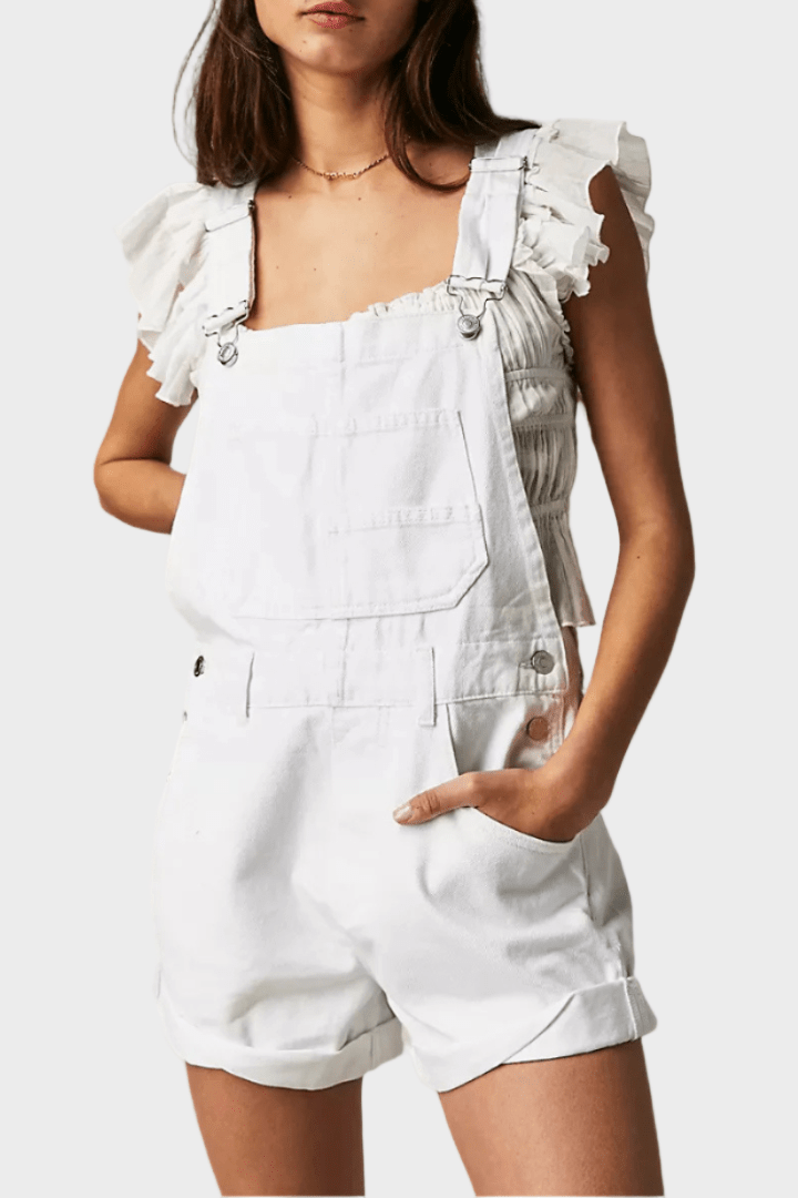 Woman wearing vintage-style denim dungaree shorts with adjustable straps
