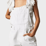 Woman wearing vintage-style denim dungaree shorts with adjustable straps