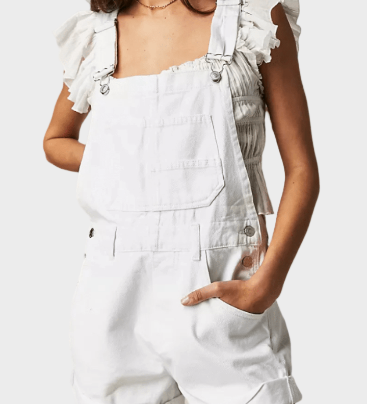 Woman wearing vintage-style denim dungaree shorts with adjustable straps