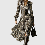 Woman wearing a rhombus print dress with belted waist