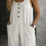 Woman wearing a sleeveless vintage-style cotton jumpsuit with square neckline