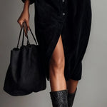 Woman wearing a corduroy button-down shirt dress
