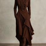 Woman wearing a draped asymmetrical maxi dress