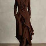 Woman wearing a draped asymmetrical maxi dress