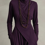 Woman wearing a draped asymmetrical maxi dress