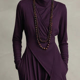 Woman wearing a draped asymmetrical maxi dress