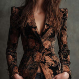 Woman wearing a black and bronze floral blazer