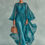 Woman wearing a statement sleeve pleated midi dress