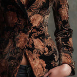Woman wearing a black and bronze floral blazer