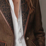 Woman wearing a herringbone panel blazer