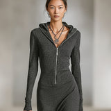 Woman wearing a long-sleeve hooded tunic dress with zip detail
