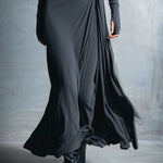 Woman wearing a long-sleeve maxi dress with an adjustable side tie