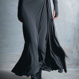 Woman wearing a long-sleeve maxi dress with an adjustable side tie