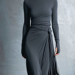 Woman wearing a long-sleeve maxi dress with an adjustable side tie