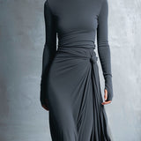 Woman wearing a long-sleeve maxi dress with an adjustable side tie