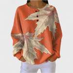 Manon Patterned Jumper in orange with cream maple leaf print, close-up front view