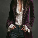 Woman wearing a long embroidered velvet jacket