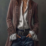 Woman wearing a long embroidered velvet jacket