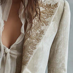 Woman wearing an ivory embroidered blazer