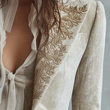 Woman wearing an ivory embroidered blazer