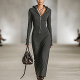 Woman wearing a long-sleeve hooded tunic dress with zip detail