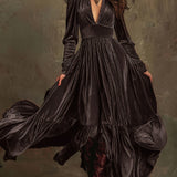 Woman wearing a deep V-neck pleated maxi dress