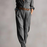 Woman wearing a tailored check jumpsuit with belt