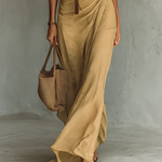 Woman wearing a wrap-style maxi dress with belt