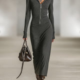 Woman wearing a long-sleeve hooded tunic dress with zip detail