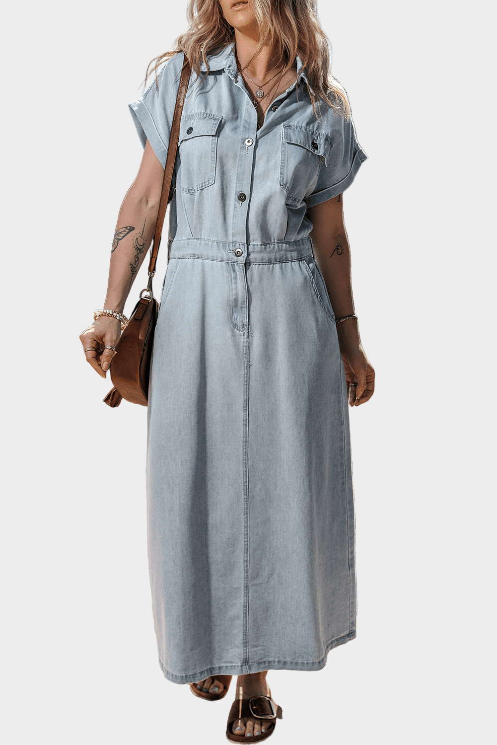 Woman wearing a long maxi denim dress with button front