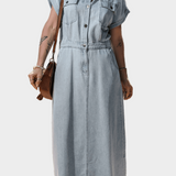 Woman wearing a long maxi denim dress with button front