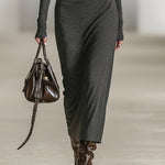 Woman wearing a long-sleeve hooded tunic dress with zip detail