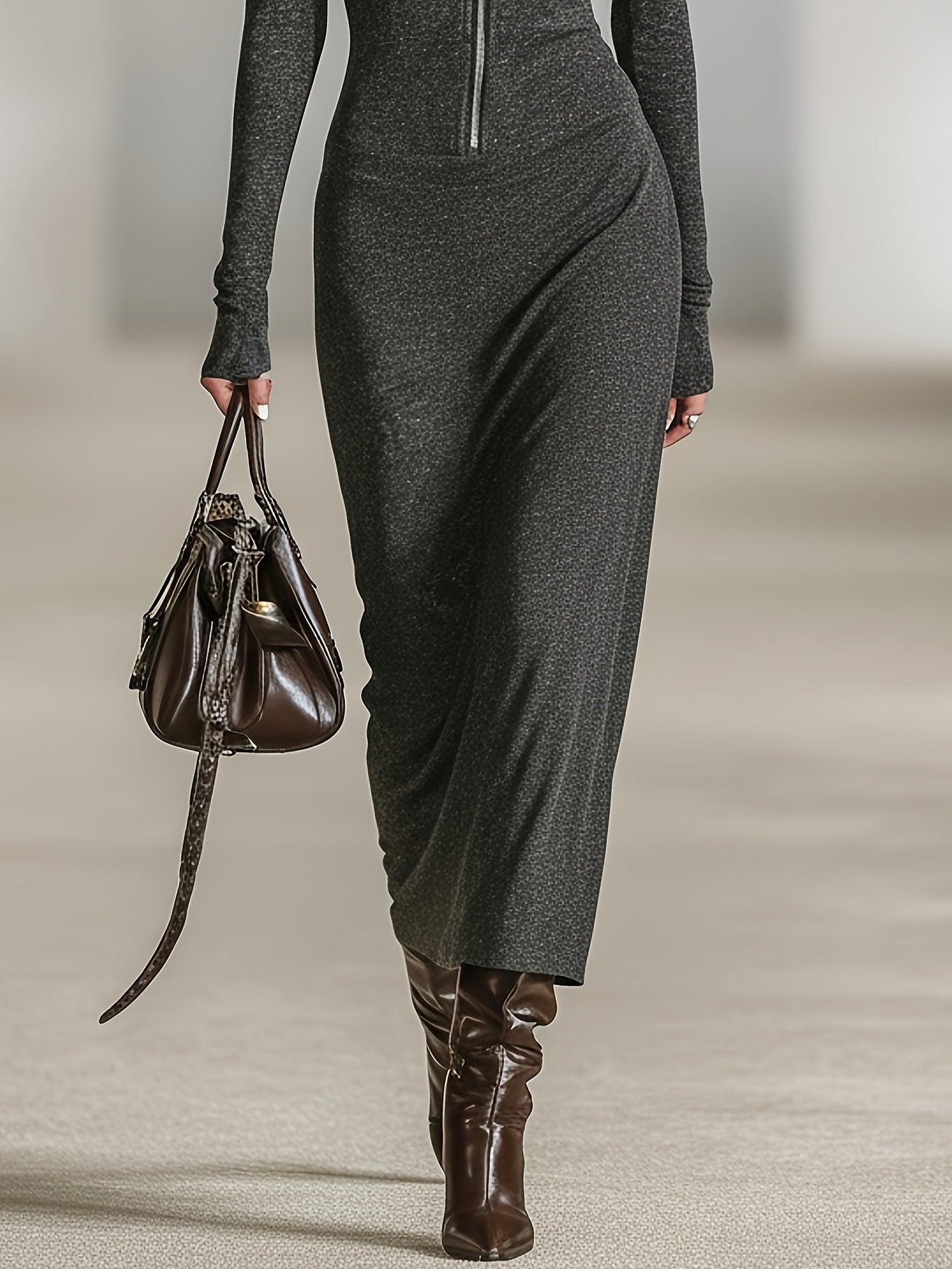 Woman wearing a long-sleeve hooded tunic dress with zip detail