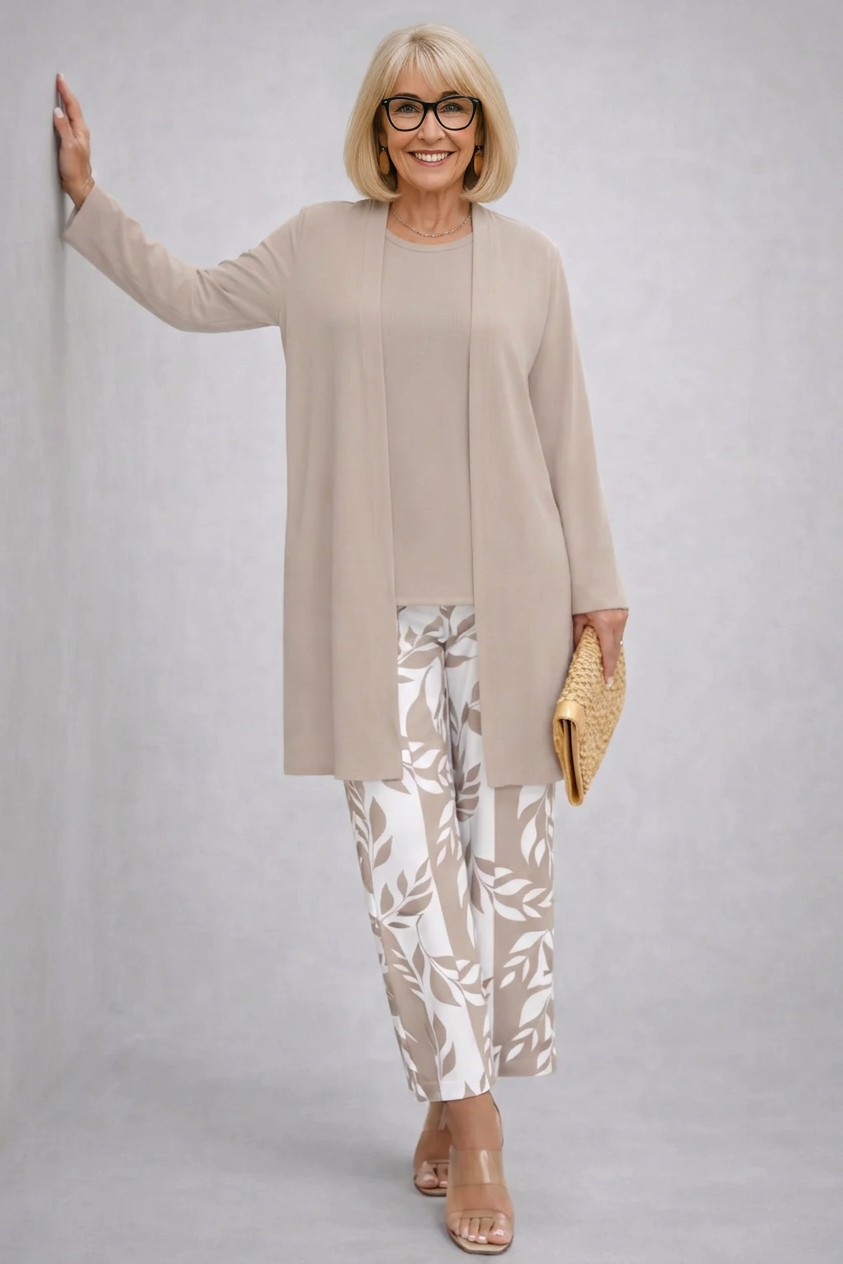 Woman wearing a cream three-piece cardigan, top and trousers co-ord set