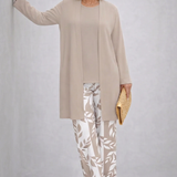 Woman wearing a cream three-piece cardigan, top and trousers co-ord set