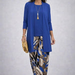 Woman wearing a patterned three-piece cardigan set with wide-leg trousers