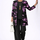 Woman wearing a purple and black three-piece cardigan, top and trousers co-ord set