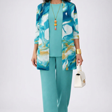 Woman wearing a turquoise three-piece cardigan, top and trousers co-ord set