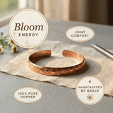 Woman wearing a floral engraved copper cuff