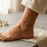 Spiral copper anklet with a hand-coiled centre design