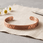 Copper cuff bracelet with a geometric pattern and hidden magnets