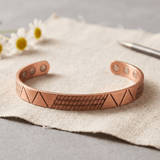 Copper cuff bracelet with a geometric pattern and hidden magnets
