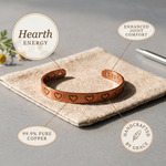 Copper cuff bracelet with a hand-stamped heart pattern